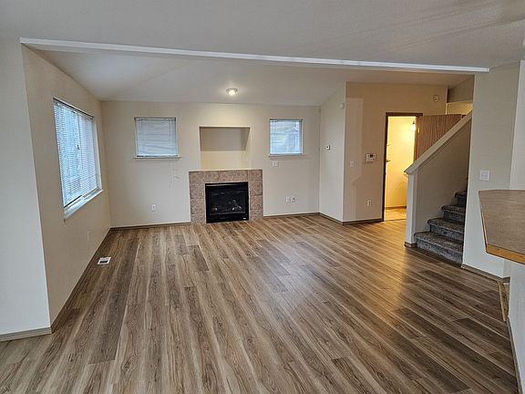 Living area with vaulted ceilings and gas fireplace.