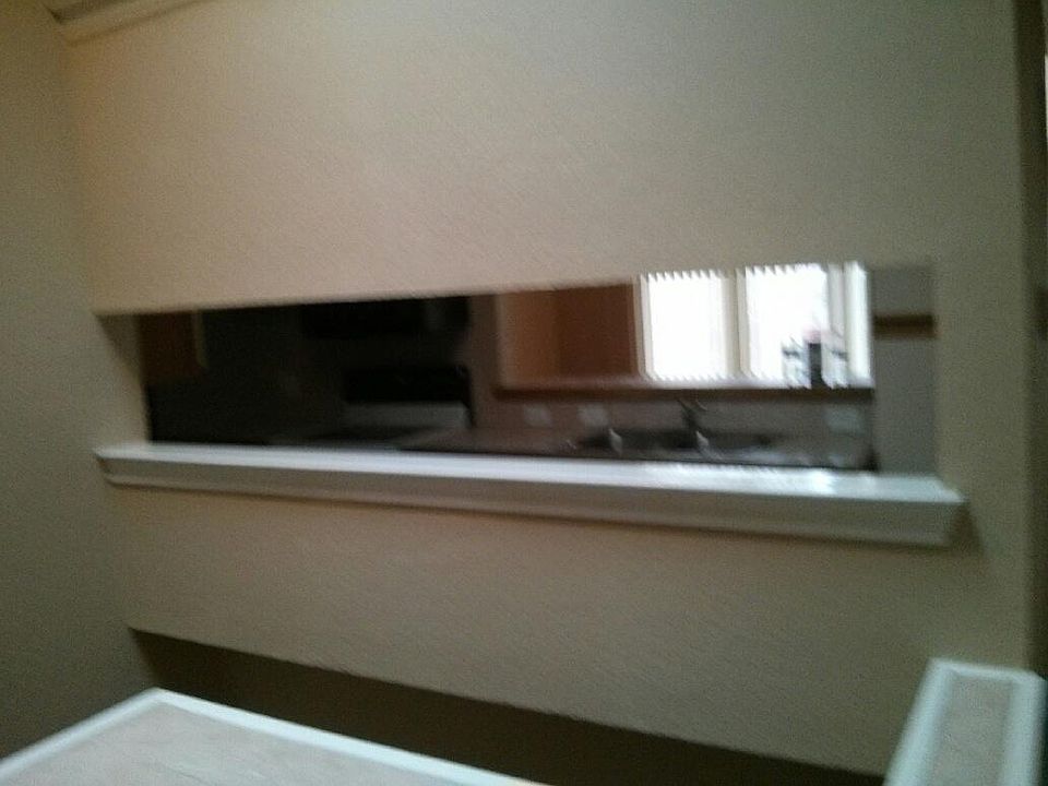 Small window into kitchen from top of stairs