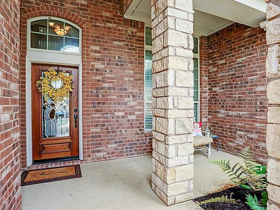 You will enter the home through the leaded glass front door with transom window to allow extra sunlight in. The oversized front patio has stone columns and a great place to enjoy your morning coffee. The beautiful tropical landscaping makes if feel v