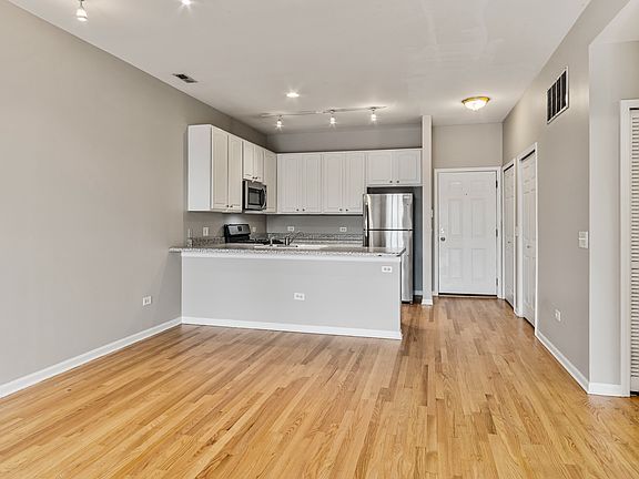 Hardwood flooring, 9-0 ceilings, stainless appliance package includes microwave, dishwasher.