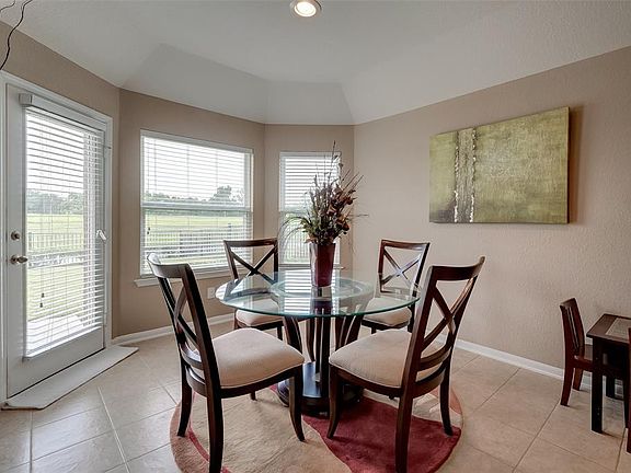 Breakfast area with lots of light overlooks backyard and water