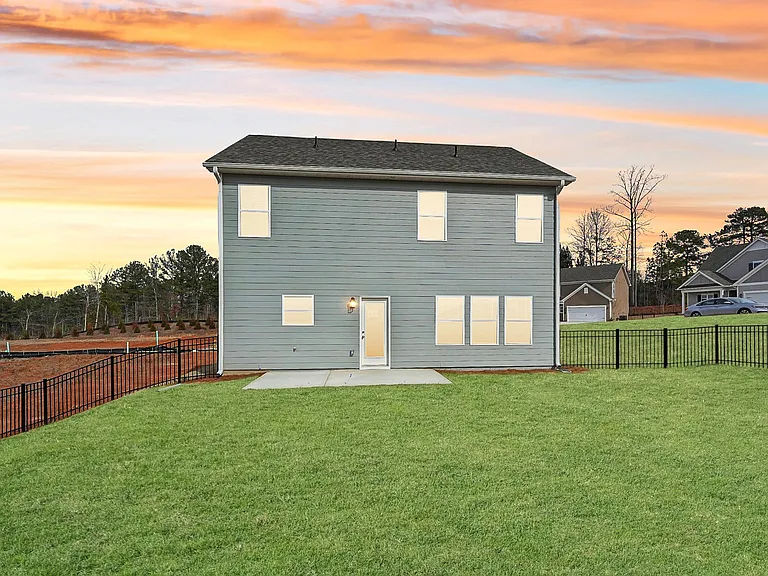 Rear view of the Alexander floor plan featuring a private patio and fenced yard.