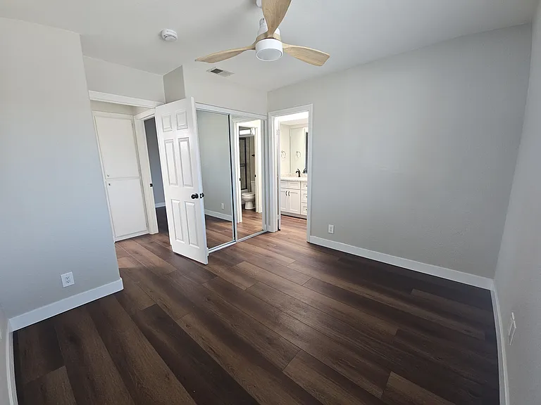 3rd upper-level bedroom with mirrored closet doors.