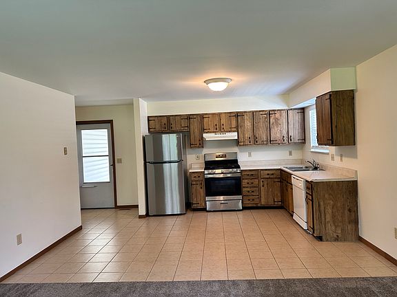 Kitchen and Living Room, with new stove and refrigerator.