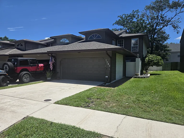 Street view. About half of the grass to the right is with the property.