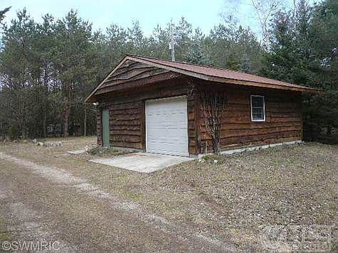 1 stall detatched garage with workshop on one side with wood stove for heat.