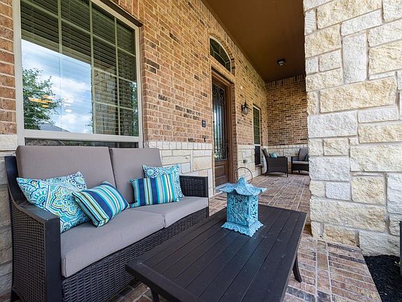 Large covered front porch with Mahogany leaded glass entry door and front porch pavers.