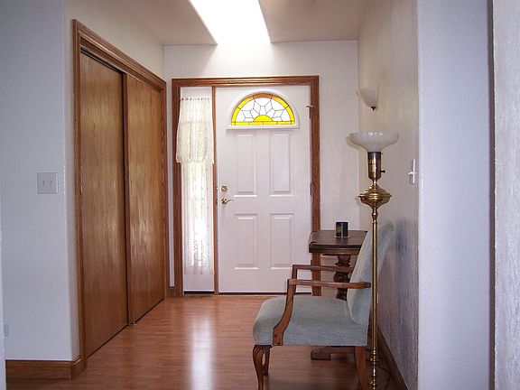 front entryway with stained glass window in door  double door closet