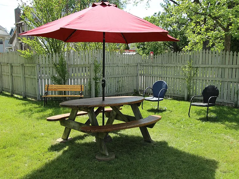 Large private backyard with brick patio & privacy fence as well as this large common green space with gas grill, firepit, lawn furniture, organic community veggie gardens and picnic table. Spacious outdoor activity, lounging space. surrounded by native &