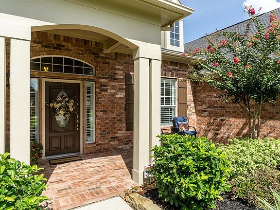 An arched walkway leads to a covered brick front porch surrounded by bushes that are sure to have the butterflies fluttering about! The exterior of this home has recently been updated with a fresh coat of paint.