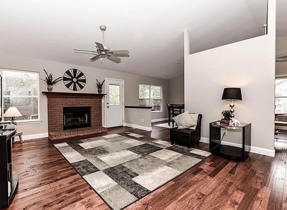 Great room with masonry woodburning fireplace and warm hickory floors