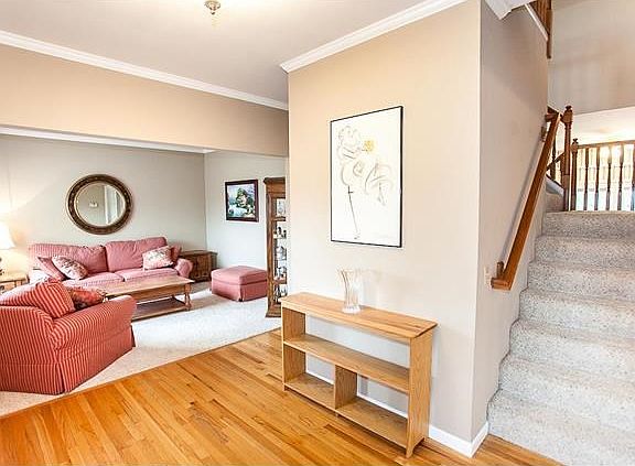 Beautiful wood flooring in foyer, split staircase.