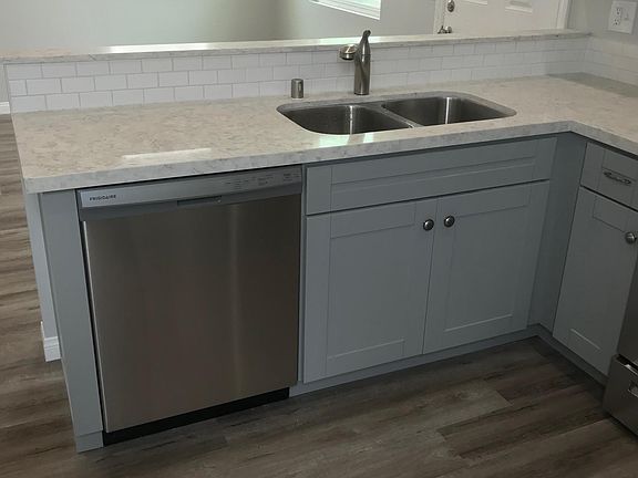 Open concept from kitchen to living room area. Tall ceilings for wonderful light and airflow