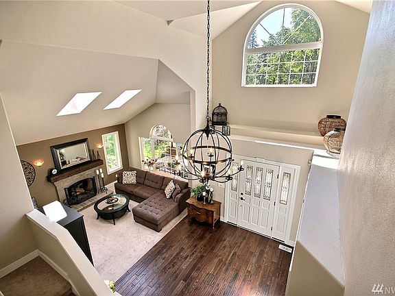 Welcome your guests to this high two story entry with newer hardwood floors