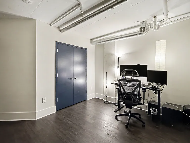 Second bedroom in the unit has is a perfect home office nook, two screen ready for your use, ergonomic chair and table that can raise to standing table height