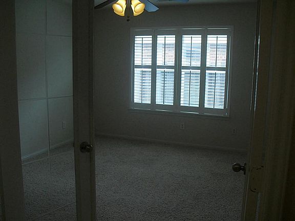 Beautiful study with glass french doors and plantation shutters.