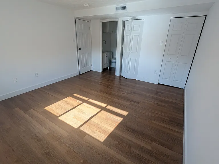 Master bedroom with linen cupboard and walk-in closet