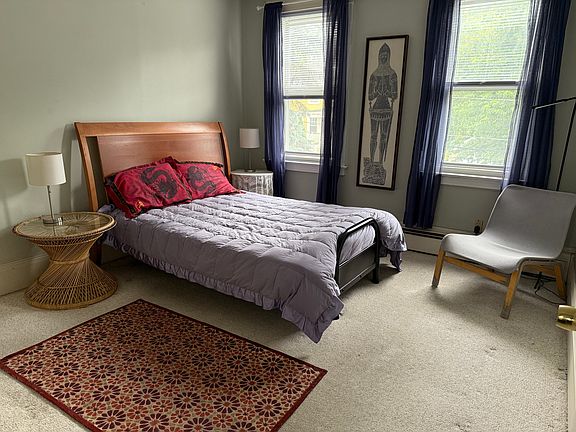Bedroom with view of Lloyd Avenue from windows. Full closet to left.