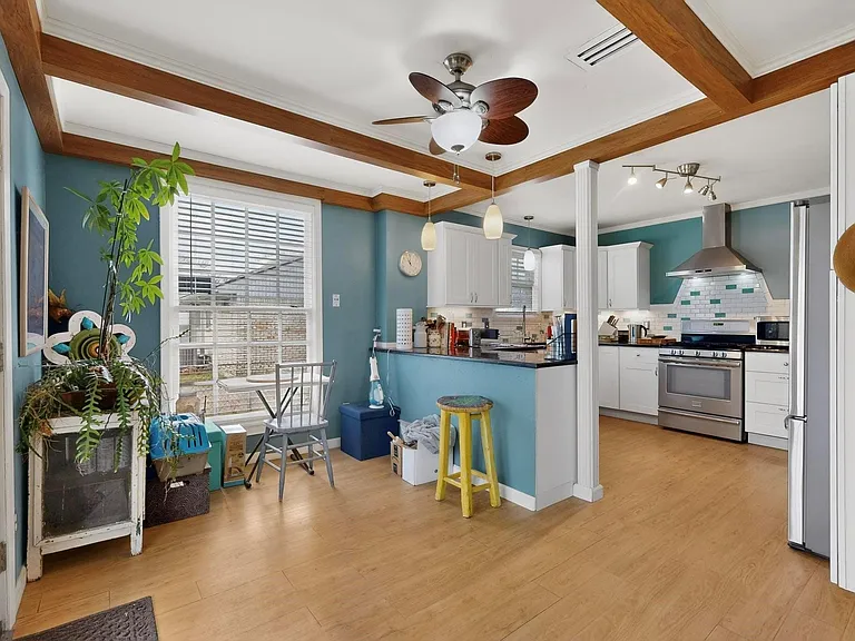 A cozy eat-in area right beside the kitchen, creating a welcoming atmosphere for intimate gathering.