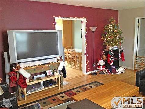 Living Room w/hallway to the bedrooms on the right and doorway to kitchen/dining to the right of the