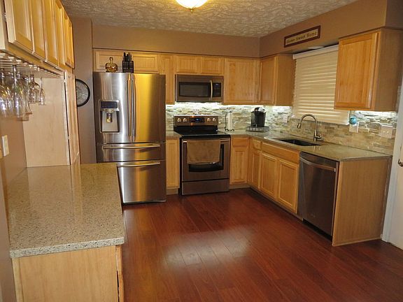 New quartz counters, backsplash, granite sink, appliances, & laminate flooring.