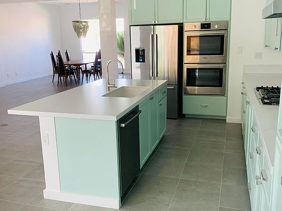 The open gourmet kitchen overlooks the living area and dining room.