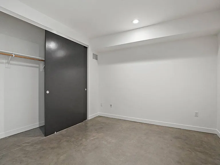 Bedroom with Recessed Lighting, Closet, and Concrete Flooring
