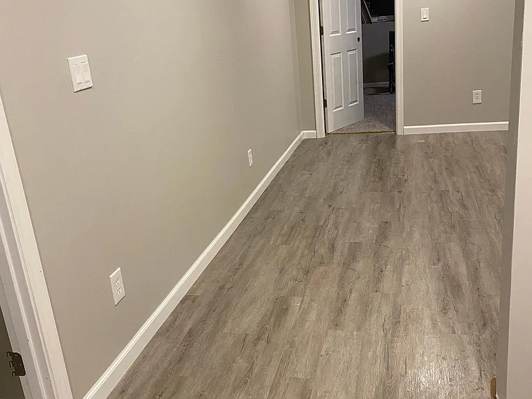 basement living room looking into bedroom 1 in basement