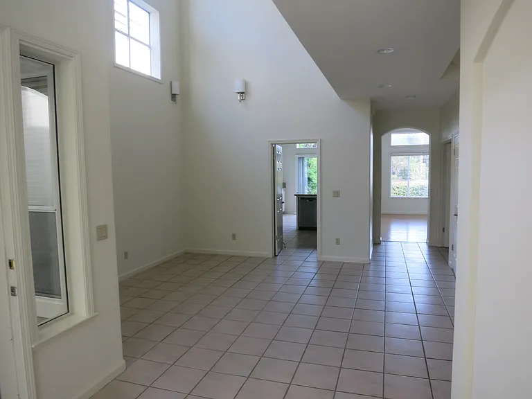 Dining area with 18 foot ceilings leading to the kitchen and family room