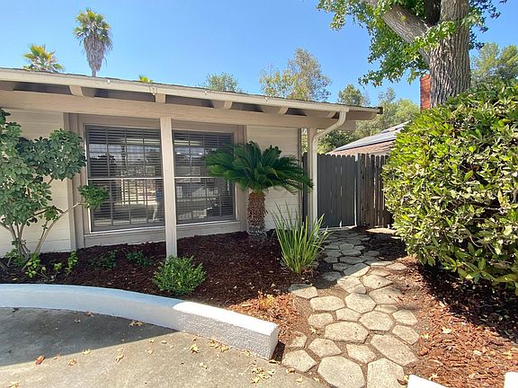 A quaint garden path to the fenced back yard