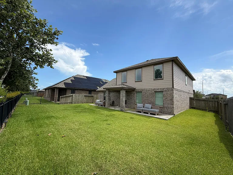 Spacious back yard with plenty of seating for large gatherings
