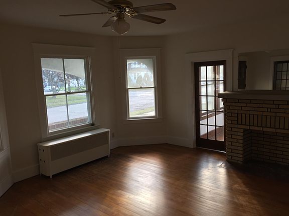 Large living room with an ornamental fire place and door to 