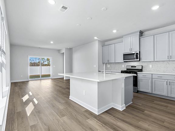 The kitchen overlooks the dining area and great room.