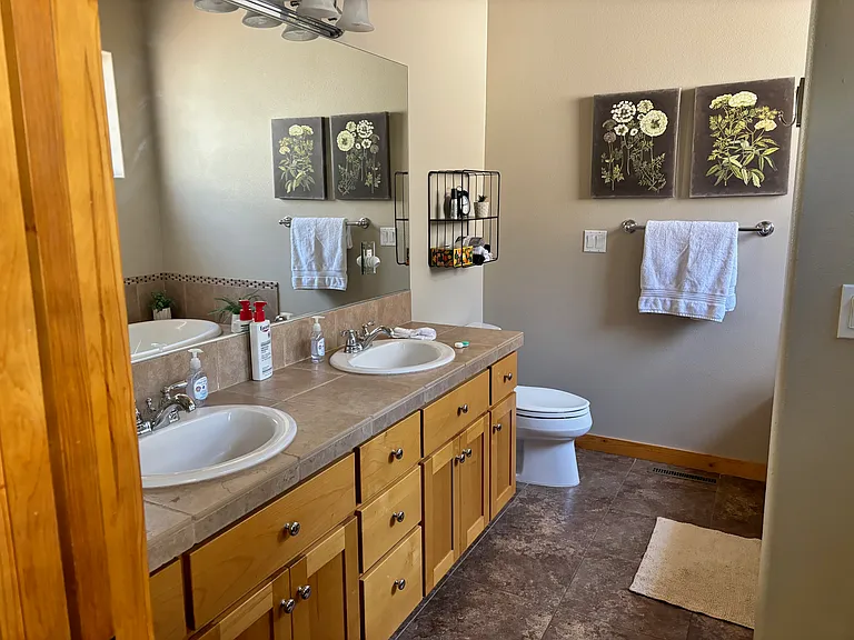 Main bathroom, double sinks, tiled shower and soaking tub.