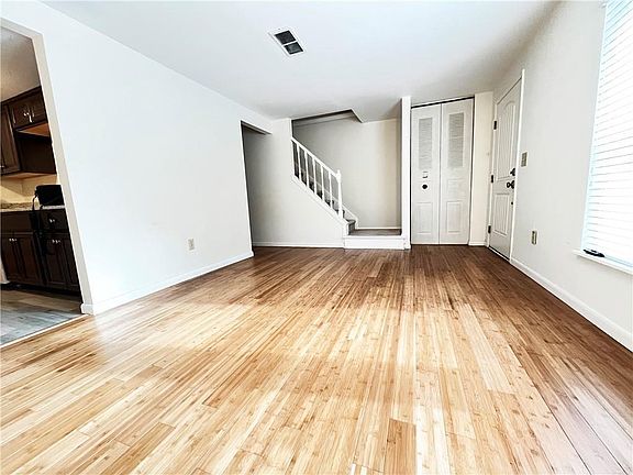 Living room, kitchen to the left and stairway to second level.