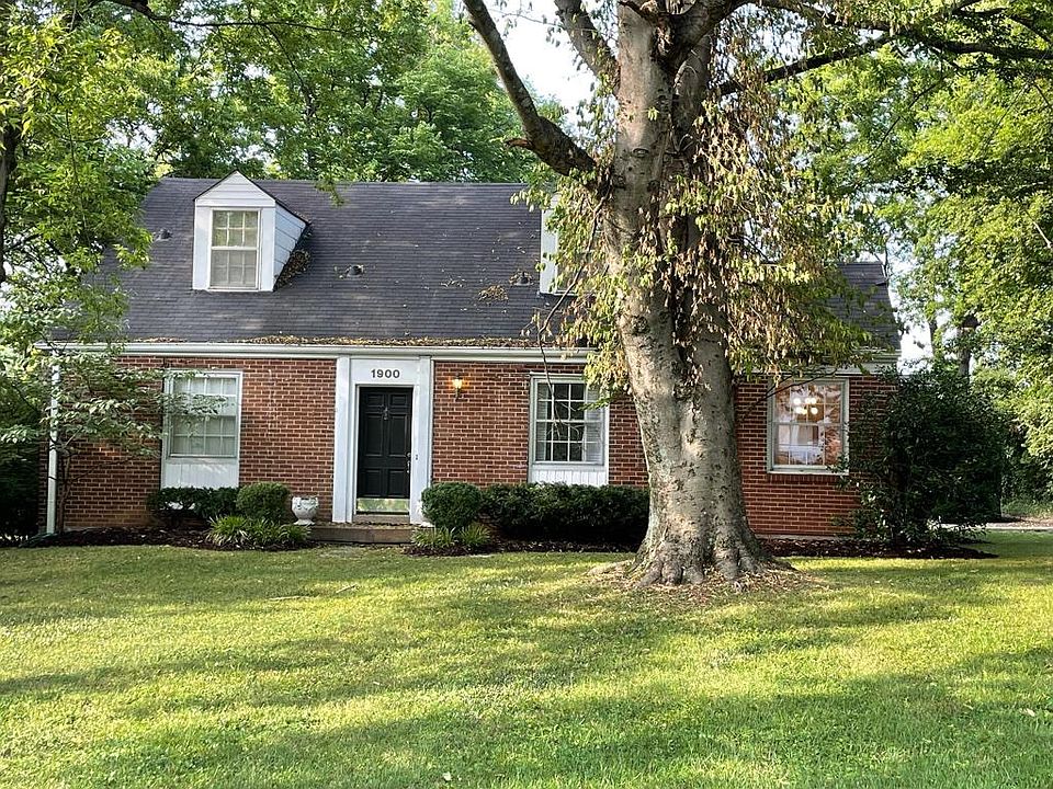 Large front yard with mature trees