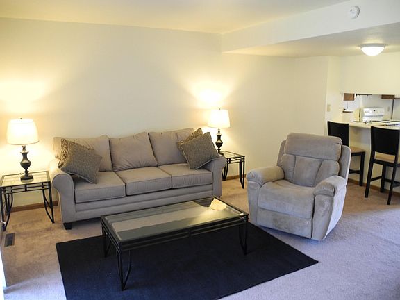 Living room has space for plenty of comfortable seating plus media