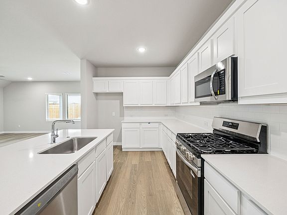 Kitchen in the Hayden home plan by Trophy Signature Homes - REPRESENTATIVE PHOTO
