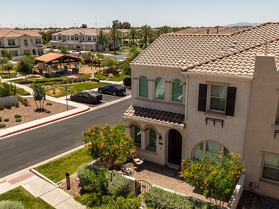 Arched windows with shutters, paved courtyard and park views.
