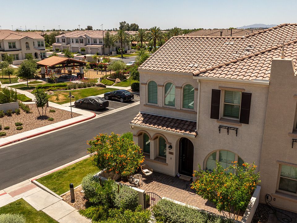 Arched windows with shutters, paved courtyard and park views.