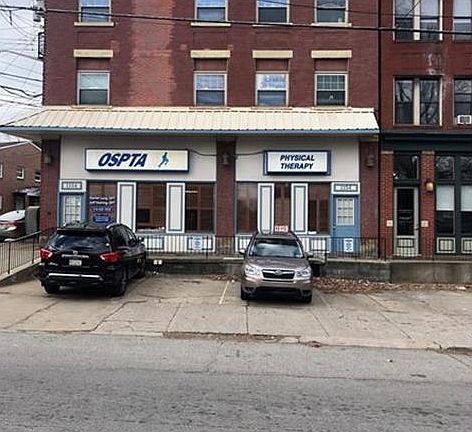 Front of building with private parking.