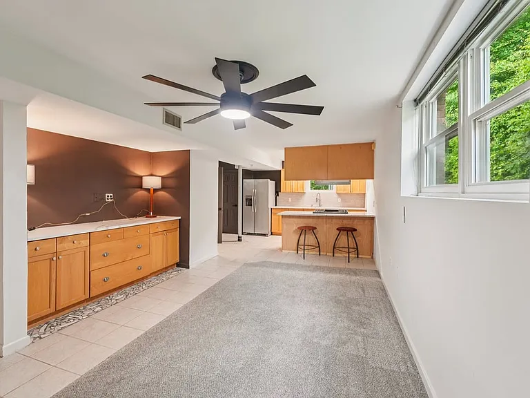 A cozy yet versatile living space where sunlight pours through the windows, the kitchenette adds everyday ease, and the layout invites endless possibilities.