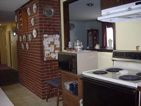 Galley style kitchen with refrigerator, dishwasher and electric range