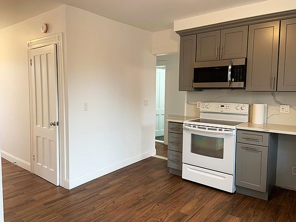 side entrance door to left, hallway to 2 bedrooms and bath