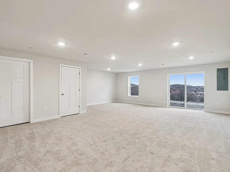 Extra large Recreation Room in Basement with natural lighting, walk out, LED lighting and storage - Ideal for entertaining and can serve multiple recreational purposes offering valuable added living space