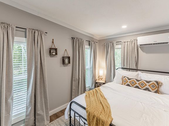 Comfortable queen size bed with big windows to allow natural light in