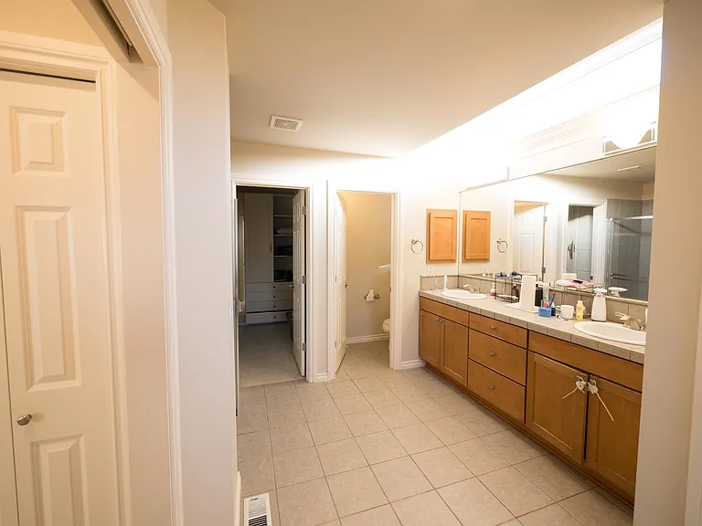 Large Master Bath with separate shower and tub. Also opens to walk in closet with wall-to-wall wardrobes.