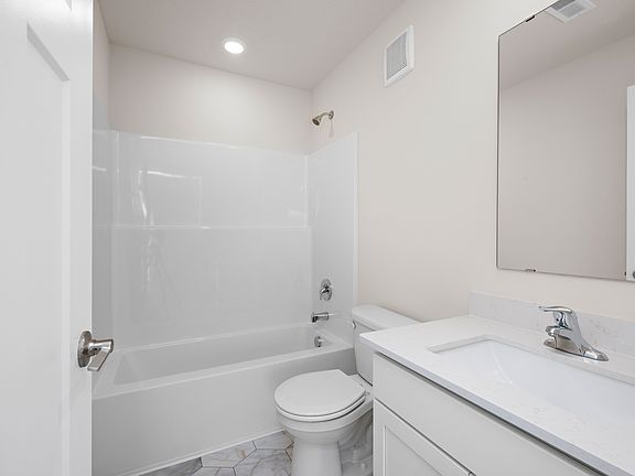 The secondary bathroom has a tub shower combo