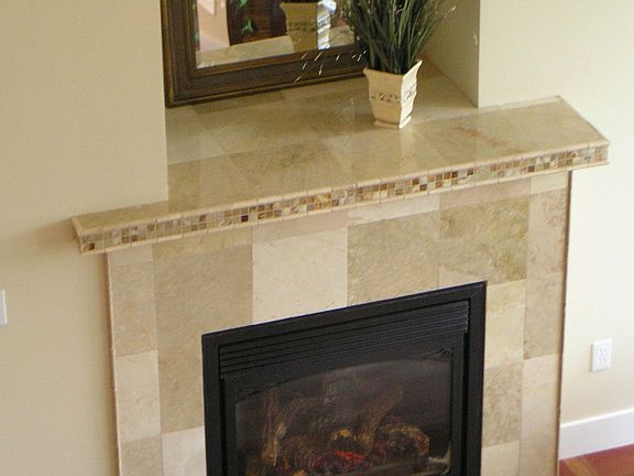 the greatroom fireplace with travertine tile surround