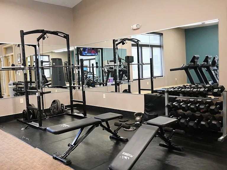 Dumbells and bench in the gym at The Sterling Kearney.